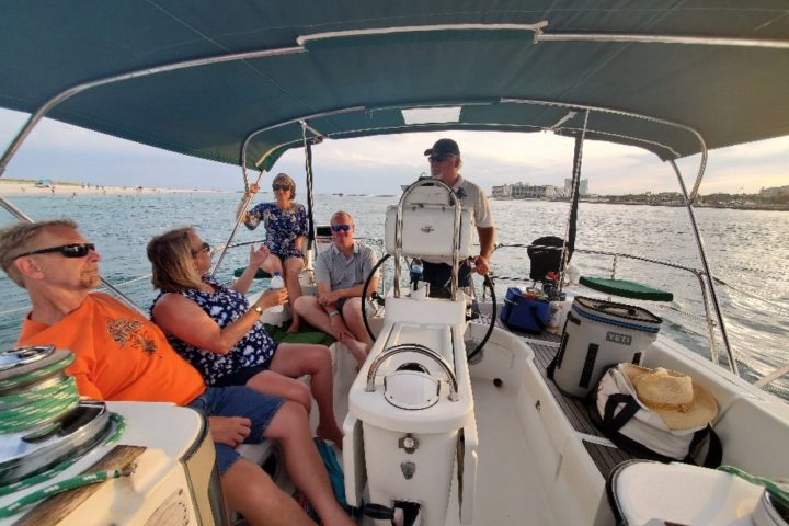 a group of people sitting in a boat on a body of water